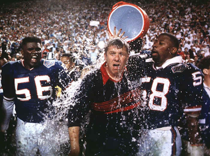 Giants linebackers Lawrence Taylor, left, and Carl Banks, right, douse head coach Bill Parcells with Gatorade after winning Super Bowl XXV.